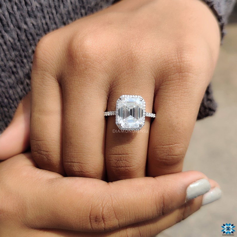Emerald cut moissanite engagement ring presented in an open ring box, ready for a proposal, with the 14k white gold band gleaming