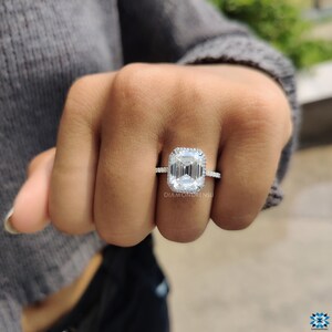 Isolated image of a white gold moissanite ring against a white background, emphasizing the purity of the ring's design