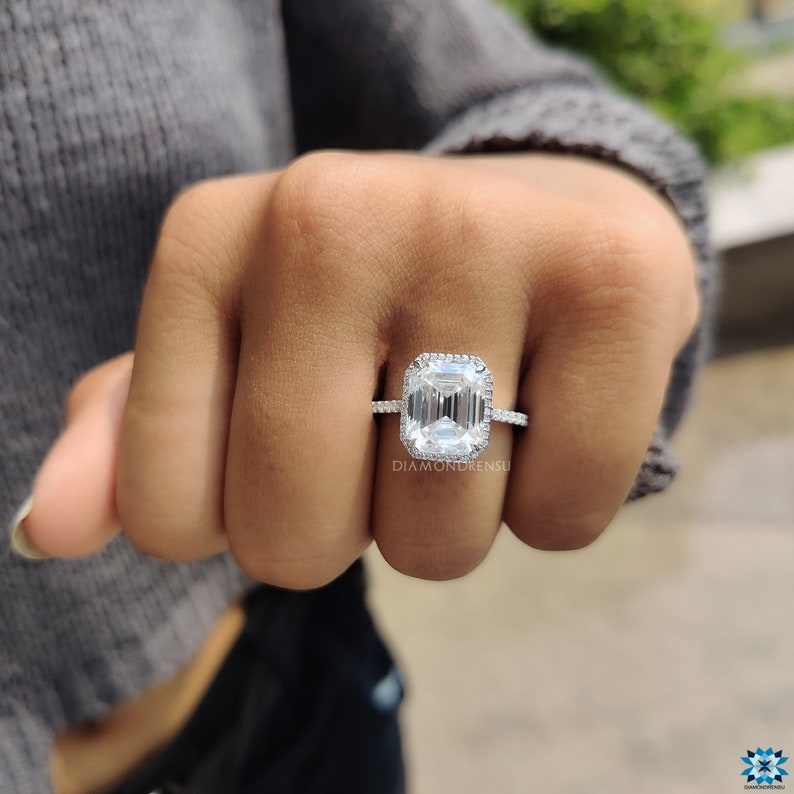Isolated image of a white gold moissanite ring against a white background, emphasizing the purity of the ring's design