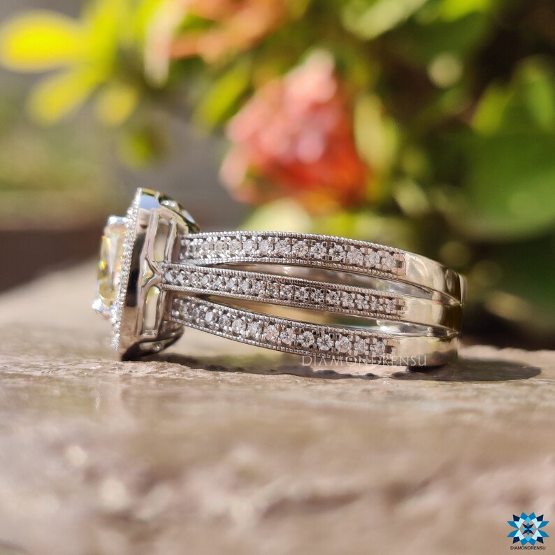 Round cut side stone engagement ring placed on a jewelry tray.