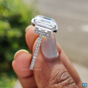Underneath view of a hidden halo ring, revealing the secret halo that encircles the lower part of the emerald cut moissanite