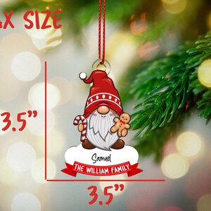May include: A red and white gnome Christmas ornament with a candy cane and gingerbread man. The ornament is 3.5 inches in diameter and has the text "Samuel THE WILLIAM FAMILY" on it.
