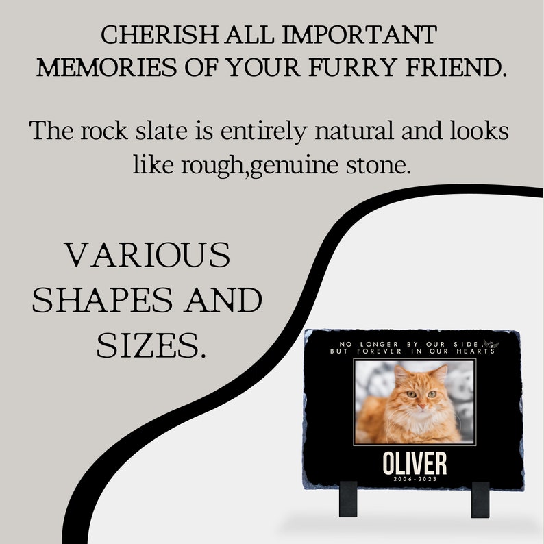 May include: Black slate pet memorial with a photo of a ginger cat and the text "No longer by our side, but forever in our hearts." The memorial also includes the name "Oliver" and the dates "2006-2023".