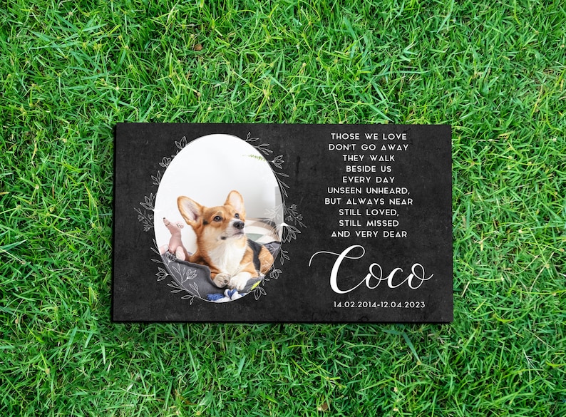 May include: Black slate pet memorial with a photo of a corgi dog. The memorial includes the text "Those we love don't go away, they walk beside us every day unseen unheard, but always near still loved, still missed and very dear." The name "Coco" is written in cursive with the dates "14.02.2014-12.04.2023".