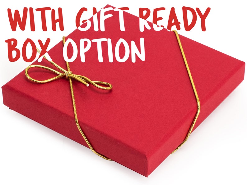 May include: A red gift box with a gold ribbon tied in a bow. The box is ready for gift giving and has the text "WITH GIFT READY BOX OPTION" printed on the top.