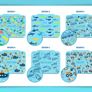 May include: Six different designs for personalized lunchboxes. Each design features a different pattern, including dinosaurs, sharks, construction vehicles, and underwater creatures. The lunchboxes are blue with white accents and have a name printed on each one.