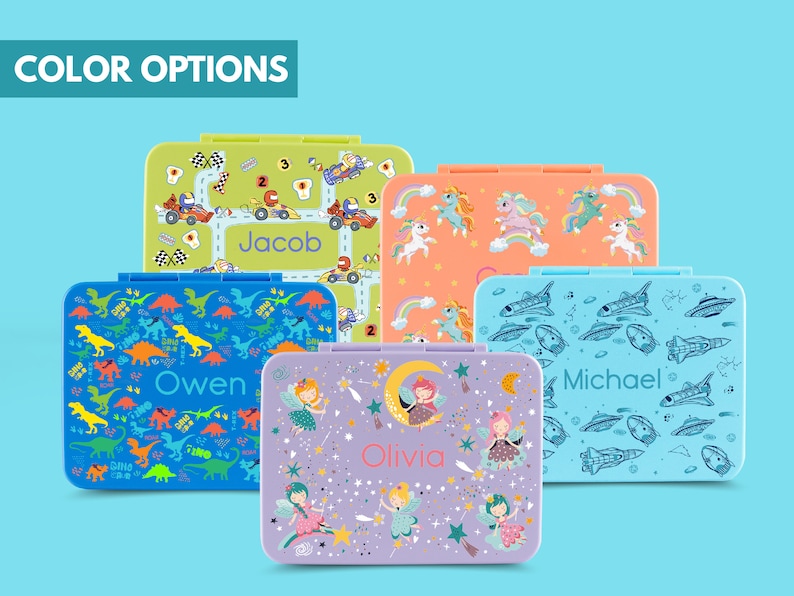 May include: Five colorful lunchboxes with different designs. The lunchboxes feature a variety of themes, including dinosaurs, race cars, fairies, unicorns, and spaceships. Each lunchbox has a personalized name on the front: Owen, Jacob, Olivia, Michael.