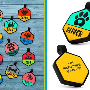 May include: Assortment of colorful dog tags with various designs and names, including a paw print, a bone, a heart, a crown, a butterfly, and a smiley face. Some tags also include the text "I am microchipped" and a phone number.