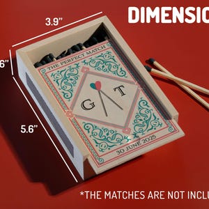 May include: A wooden matchbox with dimensions of 5.6" x 3.9" x 1.6". The box features a decorative insert with the text "THE PERFECT MATCH", initials, and the date "30 JUNE 2025". Two matches rest on a red surface. The matches are not included.