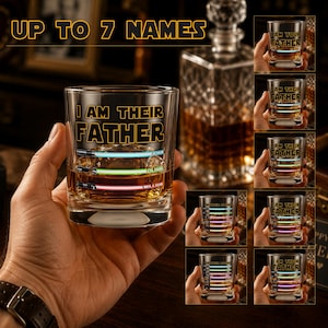 May include: A clear whiskey glass with the text "I AM THEIR FATHER" and the words "UP TO 7 NAMES" above it. The glass has three horizontal light saber designs in blue, green, and red, with names below. Additional glasses are shown.