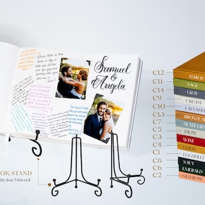 Op de afbeelding: Een wit gastenboek met een zwarte boekensteun. Het boek is open op een pagina met handgeschreven berichten en twee foto's van een stel. De boekomslag heeft de namen "Samuel & Angela" in zwarte cursieve letters. De boekensteun is gemaakt van hoogwaardig ijzer. Het boek staat op een wit oppervlak. Rechts in de afbeelding is een kleurenkaart met 14 verschillende kleuren te zien.