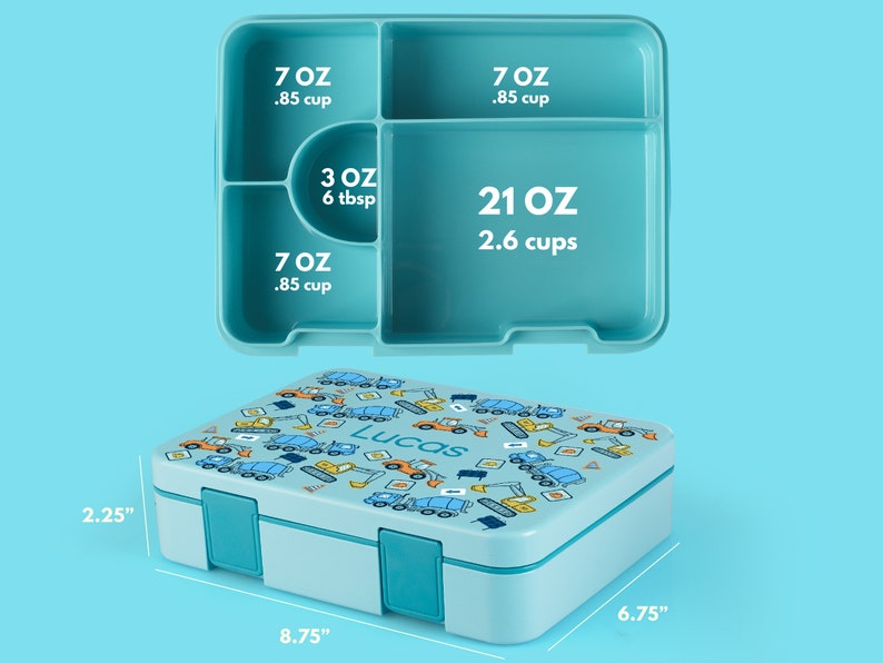 May include: A light blue lunch box with a construction vehicle print and the name "Lucas" on the lid. The lunch box has four compartments with measurements in ounces and cups. The lunch box measures 8.75 inches by 6.75 inches by 2.25 inches.