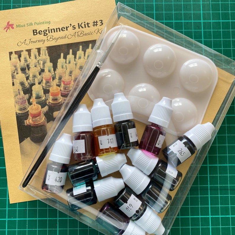 May include: A beginner's silk painting kit with 10 bottles of paint in various colors, including black, red, blue, green, and yellow. The kit also includes a plastic tray with six wells for mixing paint.