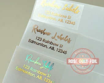 May include: Three white labels with the text "Rainbow Labels" and an address, "123 Rainbow St Edmonton, AB, 12345". The labels are printed with rose gold foil.