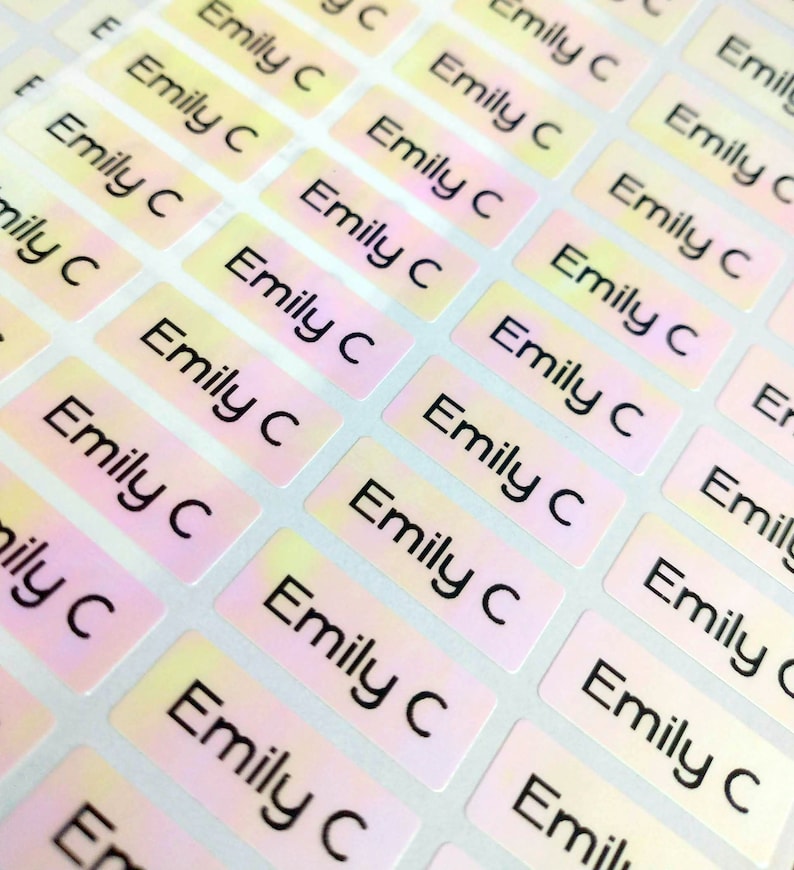 May include: A sheet of iridescent holographic labels with the name "Emily C" printed in black on each label.