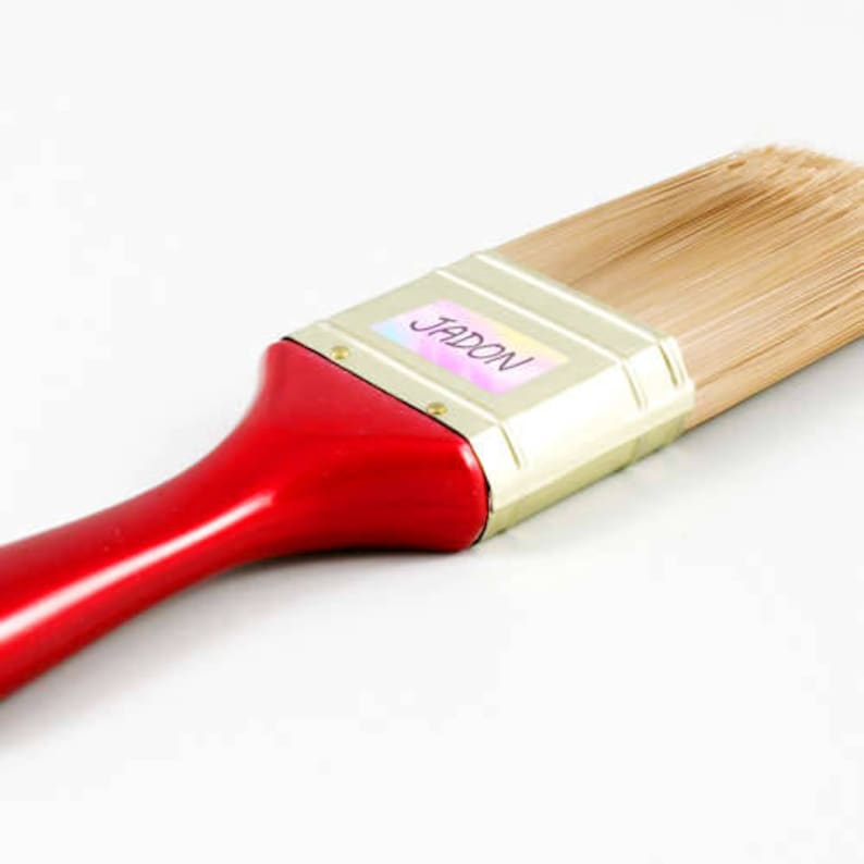 May include: A red and gold paint brush with natural bristles. The brush has a label that says "JADON".