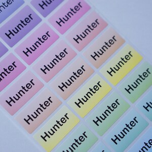 May include: A sheet of colorful rectangular stickers with the name "Hunter" printed in black on each sticker.