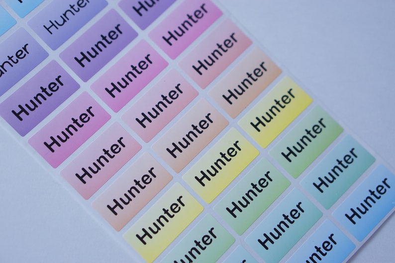 May include: A sheet of colorful rectangular stickers with the name "Hunter" printed in black on each sticker.