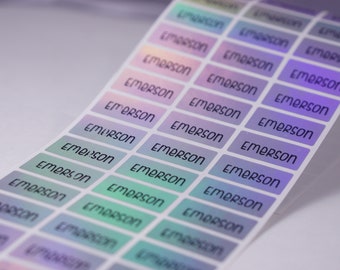 May include: A sheet of iridescent rainbow colored labels with the name "Emerson" printed in black on each label.