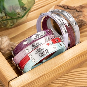 Peut inclure: Cinq colliers de chien en cuir avec des étiquettes métalliques personnalisées. Les étiquettes comprennent des noms et des numéros de téléphone. Les colliers sont de différentes couleurs, notamment le violet, le rose, le rouge et le bleu.