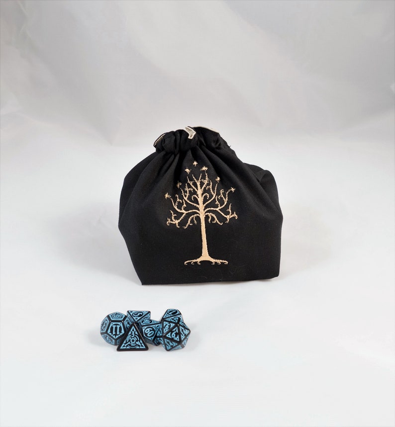 Reversible drawstring dice bag with toggle closure and square base. Ideal for D&D, board games, wargames. Features embroidered design and plain color side. Great gift for tabletop gamers