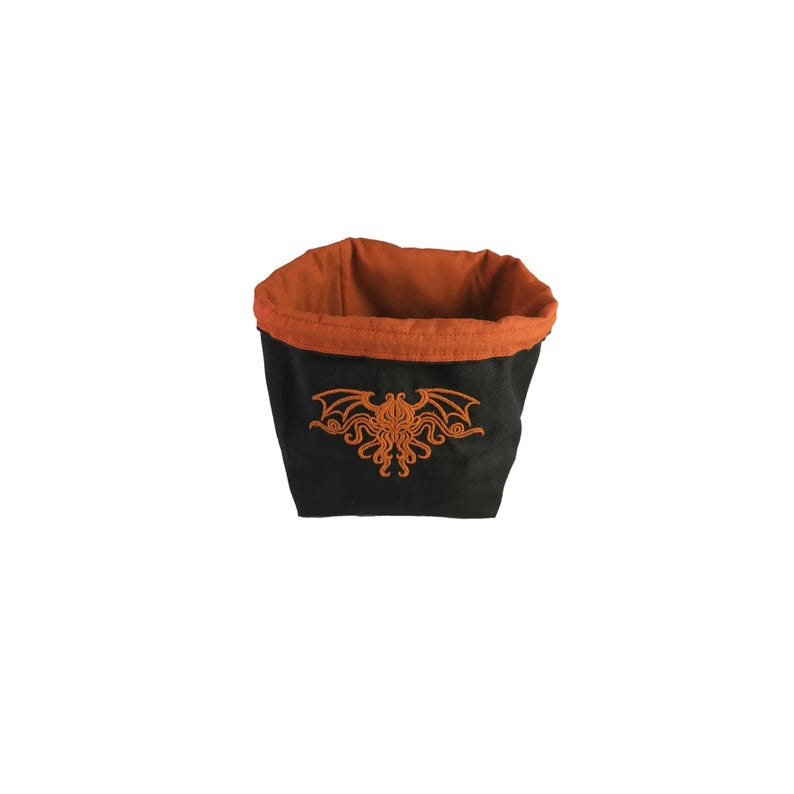 Arkham Horror Monster Cup, Reversible drawstring dice bag with toggle closure and square base. Ideal for D&D, board games, wargames. Features embroidered design and plain color side. Great gift for tabletop gamers