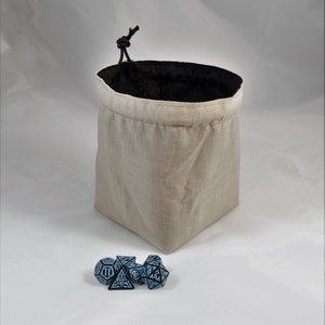 Reversible drawstring dice bag with toggle closure and square base. Ideal for D&D, board games, wargames. Features embroidered design and plain color side. Great gift for tabletop gamers