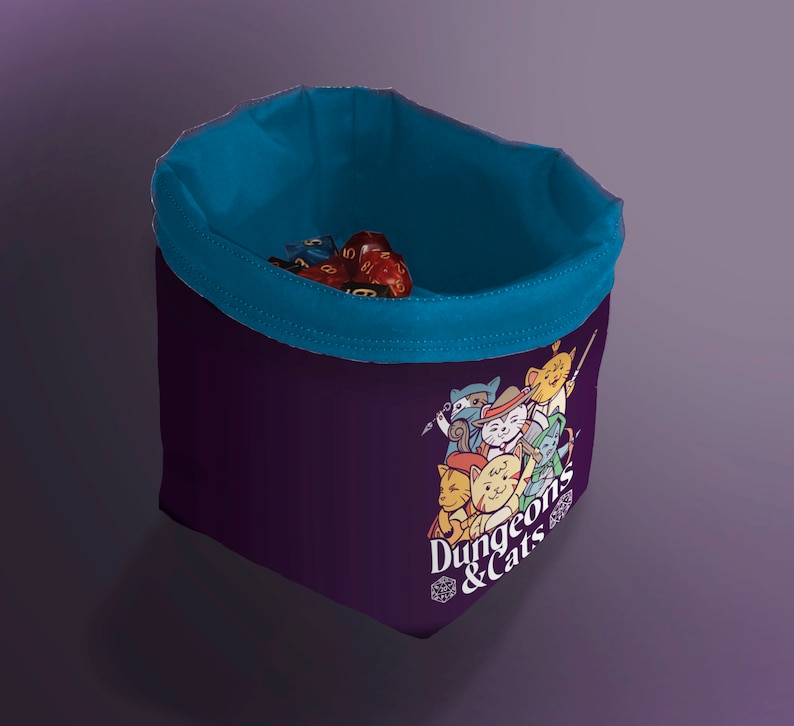 Blue Cat Dice Bag for DND – Gift for Gamers and Cat Lovers!
Bring a touch of feline charm to your next Dungeons & Dragons session with this handcrafted Cat Dice Bag, featuring a whimsical Dungeons and Cats tile pattern.
🧵 Soft, durable cotton blend exterior with a secure drawstring closure
🎁 Great gift for D&D players, cat lovers, and geeky gamers
🖐️ Handmade with care in the UK
Makes a quirky stocking stuffer, birthday gift, or surprise treat for your party’s bard, rogue, or dungeon master.