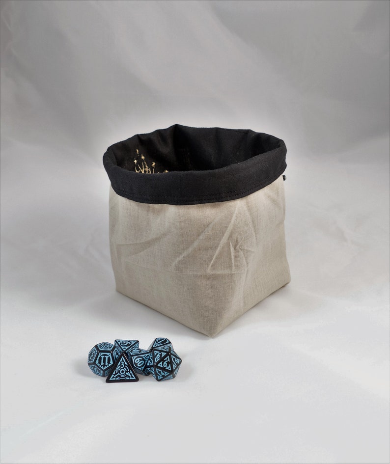 Reversible drawstring dice bag with toggle closure and square base. Ideal for D&D, board games, wargames. Features embroidered design and plain color side. Great gift for tabletop gamers