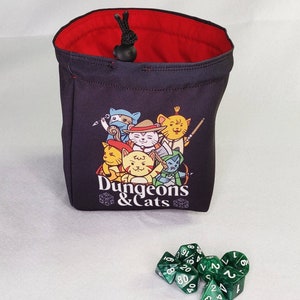 Red Cat Dice Bag for DND – Gift for Gamers and Cat Lovers!
Bring a touch of feline charm to your next Dungeons & Dragons session with this handcrafted Cat Dice Bag, featuring a whimsical Dungeons and Cats tile pattern.
🧵 Soft, durable cotton blend exterior with a secure drawstring closure
🎁 Great gift for D&D players, cat lovers, and geeky gamers
🖐️ Handmade with care in the UK
Makes a quirky stocking stuffer, birthday gift, or surprise treat for your party’s bard, rogue, or dungeon master.