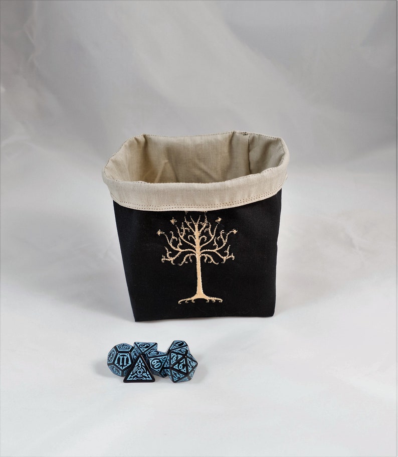 Reversible drawstring dice bag with toggle closure and square base. Ideal for D&D, board games, wargames. Features embroidered design and plain color side. Great gift for tabletop gamers