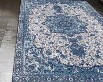 May include: A blue and white patterned area rug with a floral design. The rug is laid out on a hardwood floor in a kitchen.