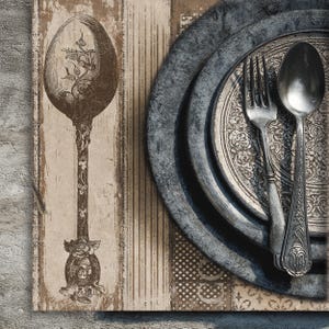 May include: A vintage-style still life featuring a large, ornate spoon with floral detailing, a fork, and a spoon resting on a decorative plate. The background includes a wooden surface with a distressed appearance, creating a rustic aesthetic.