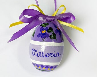 Hand painted Easter egg decorated and personalized with writing. Handwritten name with flowers. Spring decoration and floral gift for child.