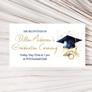 May include: A white graduation announcement with gold and navy blue accents. The text reads "You're Invited to Dillon Anderson's Graduation Ceremony" with the date and time. A graduation cap and "Class of 26" are also featured.