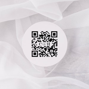 May include: White round sticker with a black and white QR code and the letters "C + H" in the center.