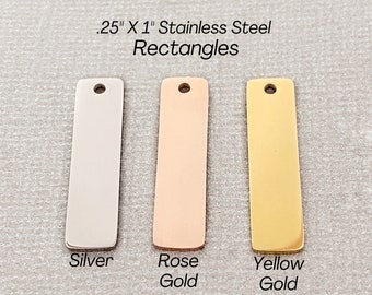 May include: Three .25 inch by 1 inch stainless steel rectangles in silver, rose gold, and yellow gold.