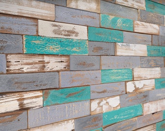 May include: A wall made of reclaimed wood planks, painted in shades of blue, gray, and white. The wood has a rustic, weathered look, with knots and imperfections.