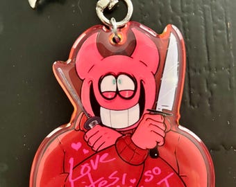 May include: A red acrylic keychain featuring a cartoon devil character holding two knives. The keychain has the text "Love bites! so do I" and the artist's signature. The keychain has a silver-colored clasp.