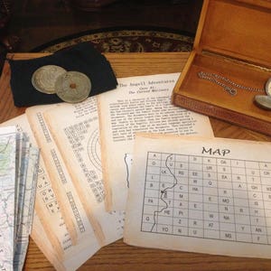 May include: A vintage-style game set with a map, a compass, and a pocket watch. The game is called "The Angell Adventures: The Cursed Mariners".