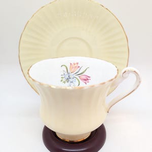 Vintage Mid Century Paragon Pastel Yellow Cup and Saucer with Delicate Tulip Floral Design on the Inside of the Cup. Made in England