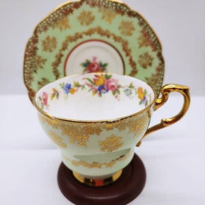 Vintage Paragon DW Cup and Saucer pale aqua green, floral design inside cup, elaborate gold on outside. Made in England