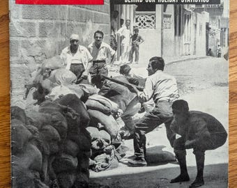 May include: A vintage LIFE magazine cover from July 7, 1958, featuring a red and white LIFE logo. The cover story is about road accidents, with the headline "Slaughter on the Road." The image shows a barricade in Beirut with people.