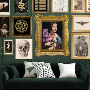 May include: A green velvet sofa with three throw pillows, one white, one green, and one black and white patterned. The sofa is in front of a wall with a gallery of framed artwork, including a skull, a snake, a planet, and a painting of a woman holding a small animal. The text "NO RIFF RAFF" is written in pink neon letters on the painting.