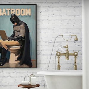 May include: A vintage-style poster featuring a superhero in a black cape and mask sitting on a toilet with a laptop on their lap. The poster has the text "BATROOM" at the top.