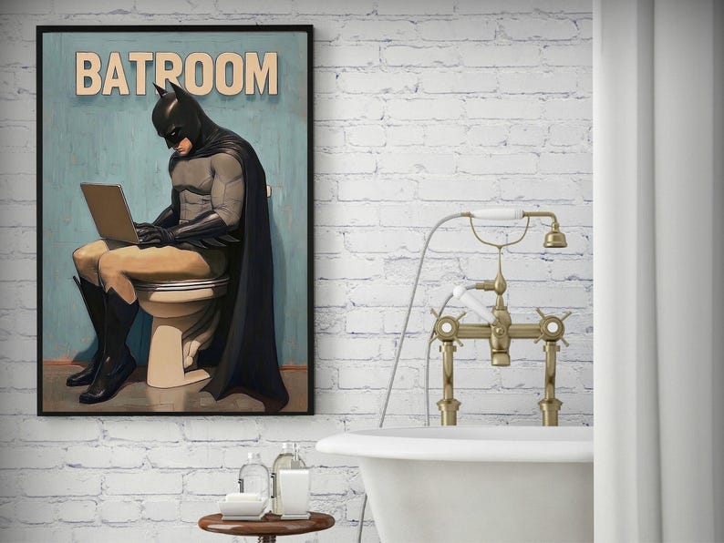 May include: A vintage-style poster featuring a superhero in a black cape and mask sitting on a toilet with a laptop on their lap. The poster has the text "BATROOM" at the top.