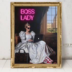 May include: A woman in a white dress and sunglasses sits in a room with a large window. She is using a laptop computer and has a black handbag next to her. The text "BOSS LADY" is in pink neon letters above her.