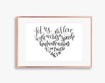 May include: A framed print with a black and white calligraphy quote that reads "Let us not love with words or speech but with actions and in truth 1 John 3:18".
