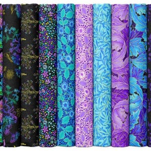 May include: A collection of fabric rolls with various floral and abstract patterns. The color palette includes shades of blue, purple, and green, with some rolls featuring black backgrounds. The fabrics are tightly rolled, showcasing the diverse designs.
