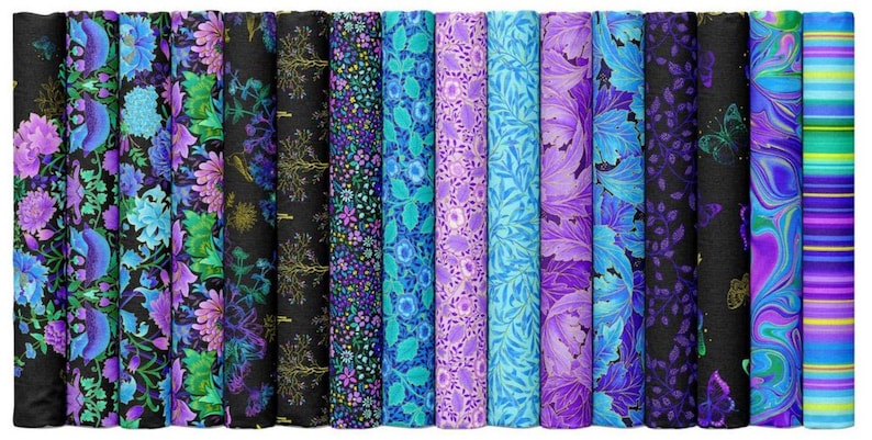May include: A collection of fabric rolls with various floral and abstract patterns. The color palette includes shades of blue, purple, and green, with some rolls featuring black backgrounds. The fabrics are tightly rolled, showcasing the diverse designs.